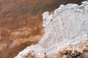 Close-up view of natural salt crust formations in the pink salt lagoon at Paracas National Reserve, Peru.