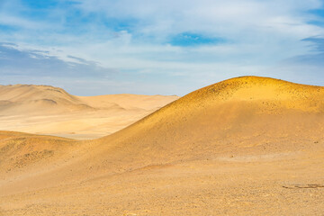 Desert dunes stretch across the arid landscape of Paracas National Reserve in Peru.