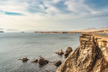 Dramatic landscape with the rocky coastline of the Pacific ocean in Paracas National Reserve, Peru.