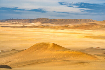 Desert dunes stretch across the arid landscape of Paracas National Reserve in Peru.