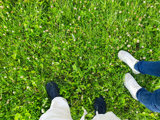 Male and female POV walking on the grass in a park,field, nature walk, physical activity.