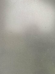 Close-up of a smooth, silver metallic texture with a gradient effect