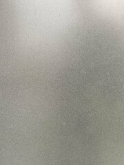 Close-up of a smooth, silver metallic texture with a gradient effect