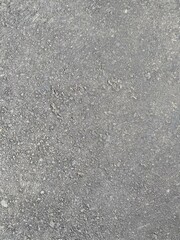 Close-up of a textured gray asphalt surface
