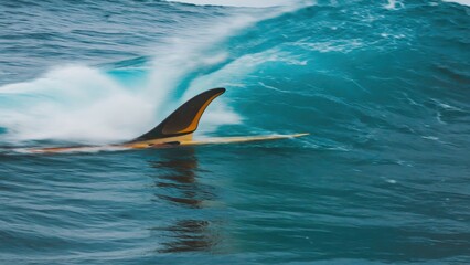 Fototapeta premium Surfboard and wave dynamics captured in action at sea