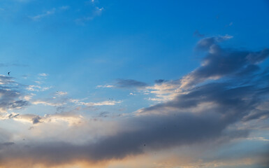 Beautiful bright sunset sky background with clouds.  Evening time.