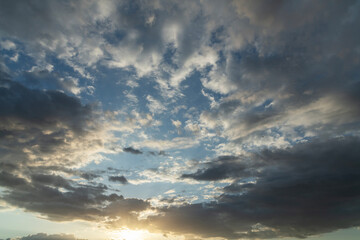 Beautiful bright sunset sky background with clouds.  Evening time.