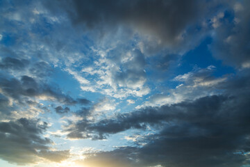 Beautiful bright sunset sky background with clouds.  Evening time.