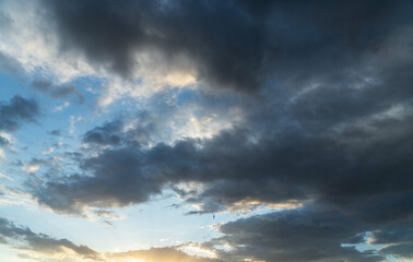 Beautiful bright sunset sky background with clouds.  Evening time.