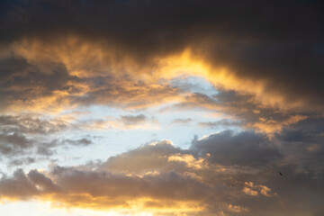 Beautiful bright sunset sky background with clouds.  Evening time.