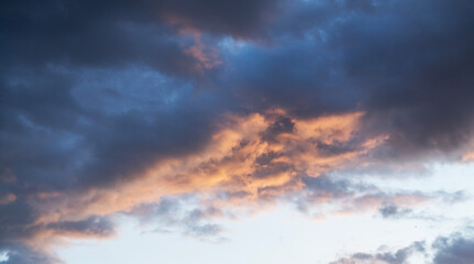 Beautiful bright sunset sky background with clouds.  Evening time.