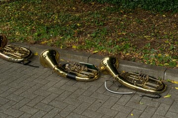 Baritone horns resting on sidewalk after open air concert