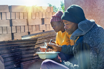 africa village, african man and woman eating hot food outdoors, poverty food security , welfare charity organizations