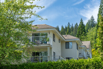 Top of modern apartment building with balcony, trees and beautiful landscape in Vancouver, Canada, North America. Day time on June 2025.