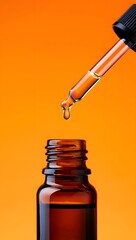 Essential oil dropper bottle aromatherapy liquid medicine alternative health care orange background