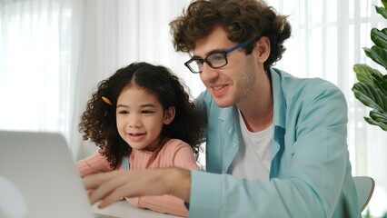 Father explain generate AI while american girl looking at screen. Attractive caucasian dad teaching...