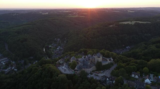Schloss Burg, castle in Sollingen, overlooking the river Wupper, Medieval castle in the german hills. Aerial video at sunset