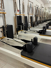 Pilates studio with multiple reformers ready for a workout session