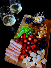 Elegant Charcuterie Board with Wine and Fresh Fruits
