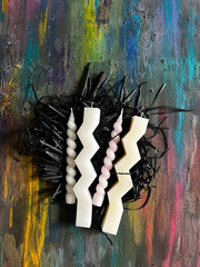 Artistic Candle Arrangement on Textured Surface