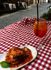 Eggplant Parmesan with Aperol Spritz in an Italian Restaurant Setting