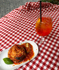 Eggplant Parmesan with Aperol Spritz in an Italian Restaurant Setting