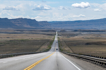 Panoramic drivers view over US Highway 191 in the desert in southerly direction between Wellington and Green River, UT, USA with mountain range on horizon