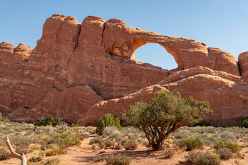 Landmark geological sandstone formation Skyline Arch against a blue sky in Arches National Park, Moab, UT, USA