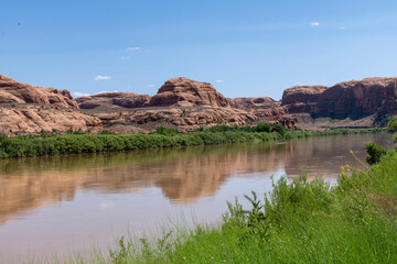 The Colorado River along the Potash Road near Moab, Utah, USA with geological sandstone formations reflected in the tranquil water
