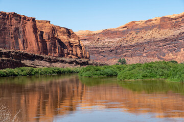 The Colorado River along the Potash Road near Moab, Utah, USA with geological sandstone formations reflected in the tranquil water