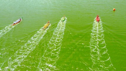 Top down view of the rougher competition between the teams on rowing boats on the pond.