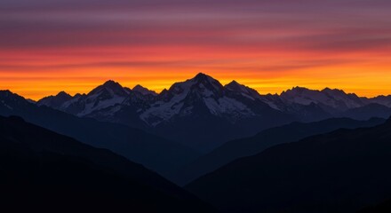 Sunset paints the sky as mountains stand in dark silhouette