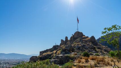 Ruins and fragments of walls of medieval Crusader castle, built in XV century by Knights Hospitaller of Order of St. John on hill above city of Fethiye, Turkey