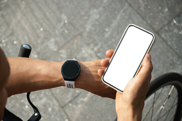 Cyclist checking geolocation, timer, distance, heartbeat or fitness progress after riding in apps...