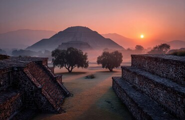 Sunrise illuminating teotihuacan pyramid of the sun with ground fog and trees