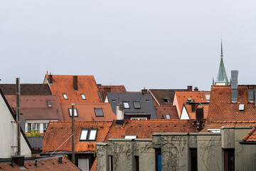 Urban Rooftops with Assorted Architectures and Spire in Background