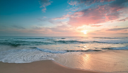 Obraz premium Soft Pastel Sunset Over Calm Ocean Beach