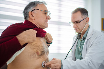 Elderly man receives health checkup in a bright clinic room