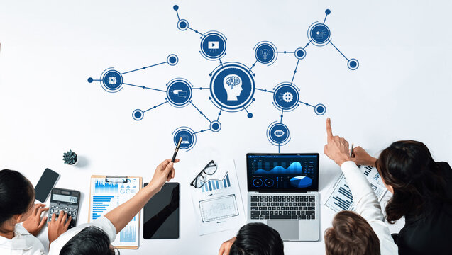 A diverse team collaborates on artificial intelligence concepts, featuring data visualization and analytics in a modern business workspace, enhancing innovative strategies. Amity