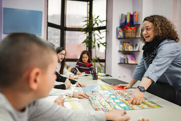 Woman teaching a group of elementary students at language school