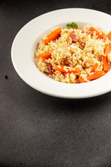 Rice meat and vegetables pilaf fresh delicious gourmet food background on the table rustic food top view copy space