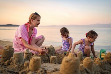 Building sandcastles together at sunset on a beautiful beach