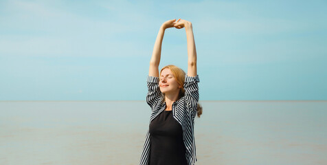 Summer vacation, happy relaxing young woman meditates on the beach on sea