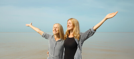 Summer vacation of two women smiles on the beach, happy caucasian girlfriends together on sea