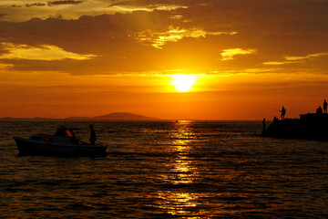 Summer vacation activities during fiery orange sunset
