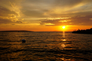 Summer sunset scenery on the seacoast in orange and brown color tone
