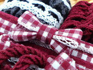 Colorful textile patterns showcasing intricate design details with bows and lace in a variety of colors and textures