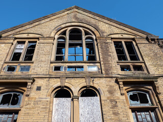 Burned out derelict old industrial stone building with roof open to the sky in Bradford West...