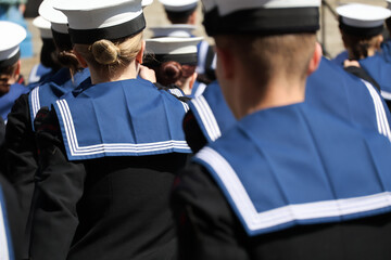 Navy sailors in uniform with their backs to camera Uniformed Heads and Hats from Behind: Naval Style