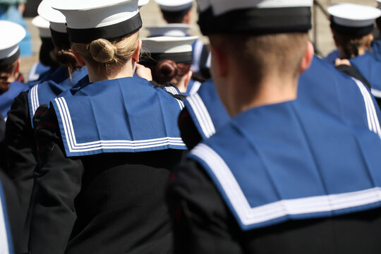 Navy sailors in uniform with their backs to camera Uniformed Heads and Hats from Behind: Naval Style
